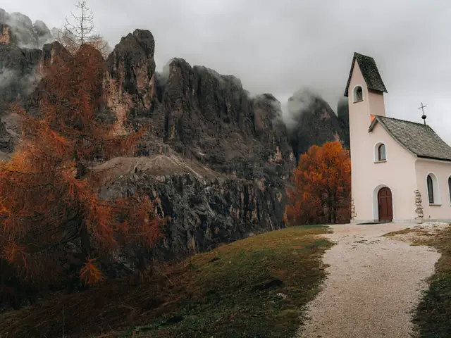 A pilgrim path crosses a golden landscape toward a church.